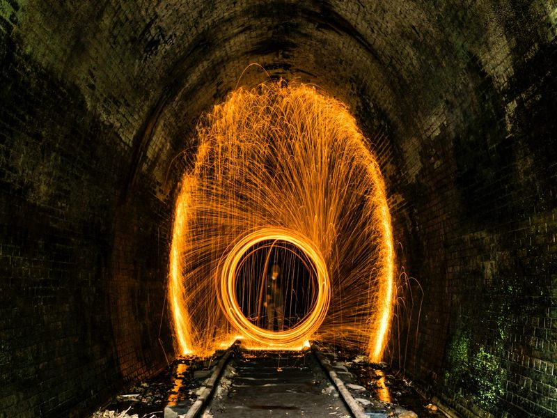 Abstract glowing lines showing path of movement in dark space